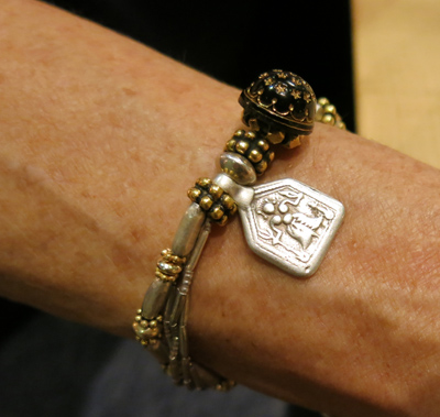 Detail of 4 Strand Silver and Gold Bracelet with Antique Silver Deity Amulet, Rajasthan, India with Victorian Etched Black Glass Button,England Detail of 4 Strand Silver and Gold Bracelet with Antique Silver Deity Amulet, Rajasthan, India with Victorian Etched Black Glass Button, England